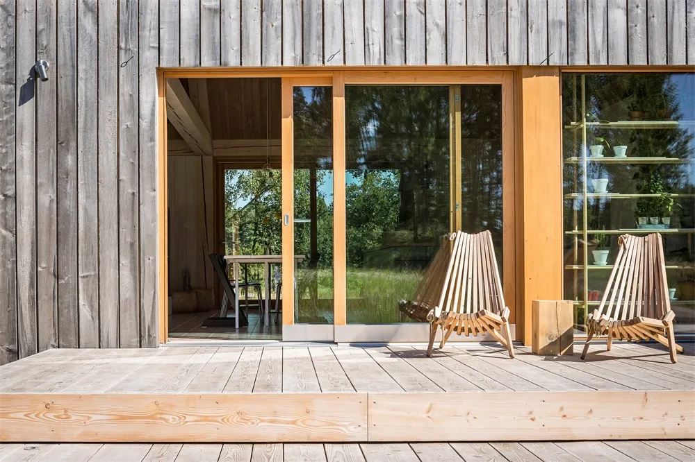 Modern, minimalist exterior of a residential home with wooden materials and clean lines.