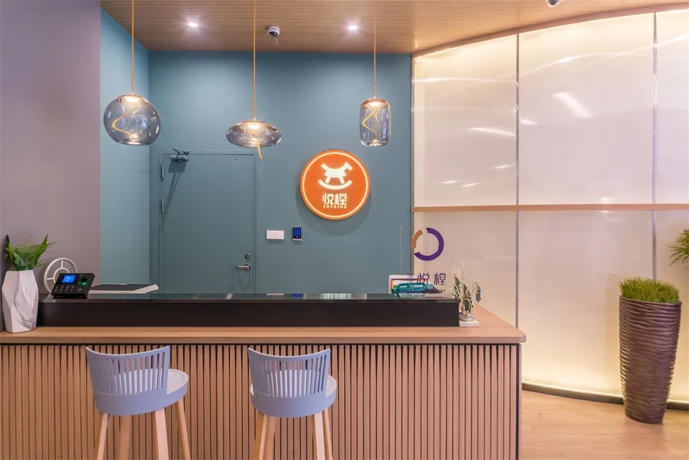 Modern wooden reception desk with glass top and metal legs