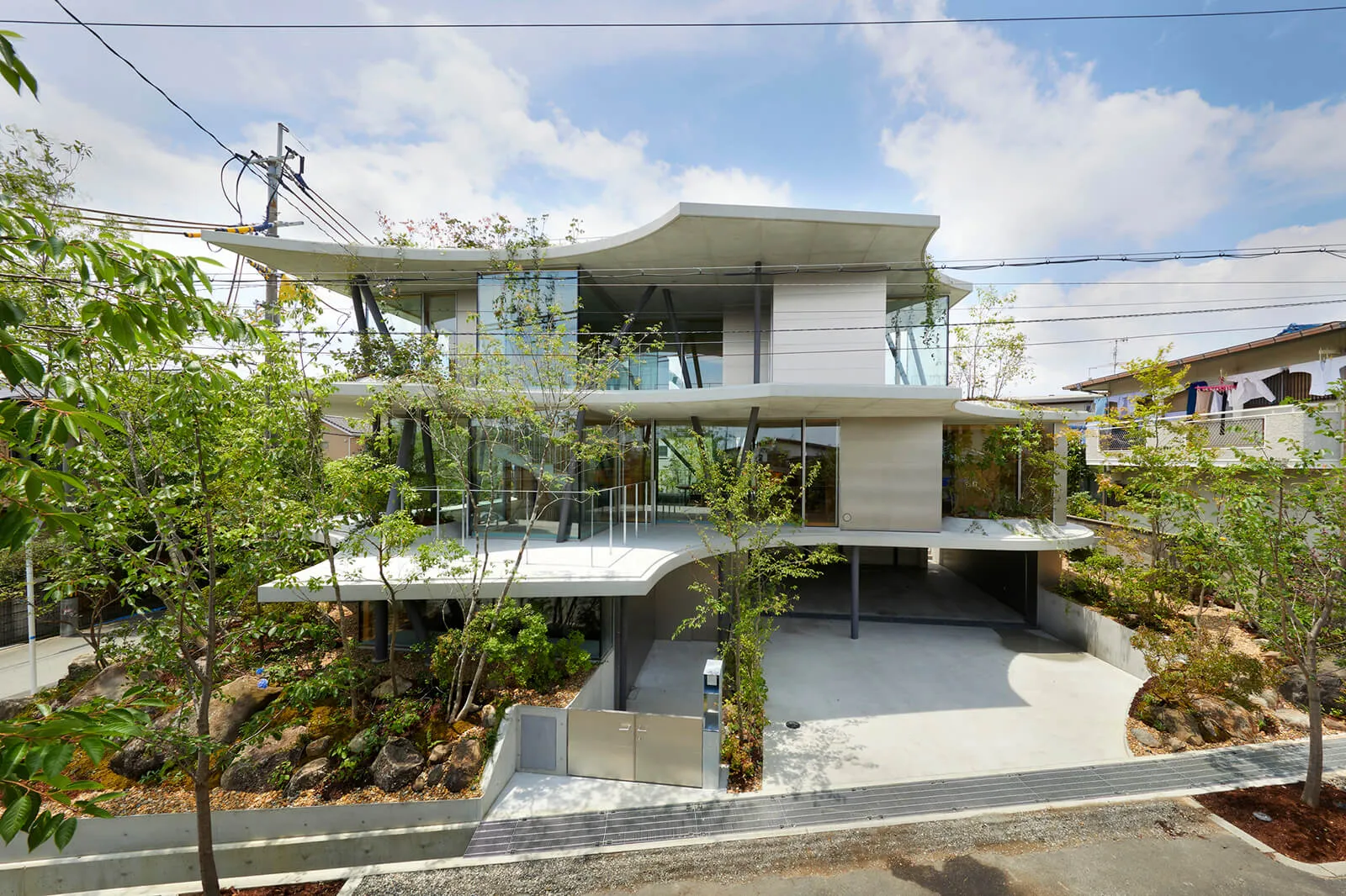 A modern concrete house with a unique, futuristic design.