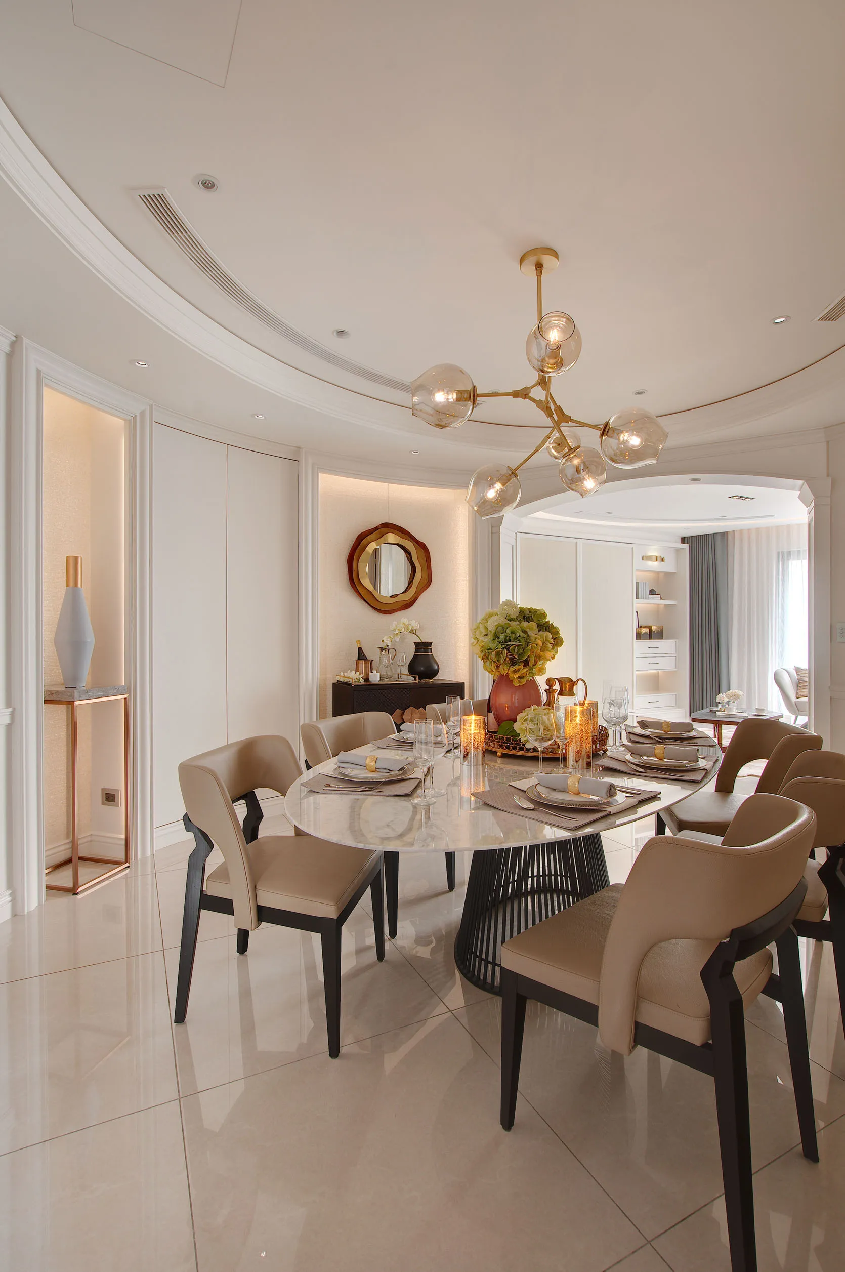 Modern dining room with marble table, leather chairs, and metal accents