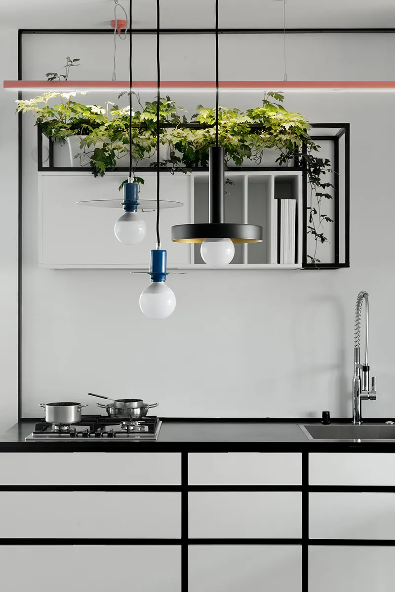 White kitchen with black countertops and minimalist design