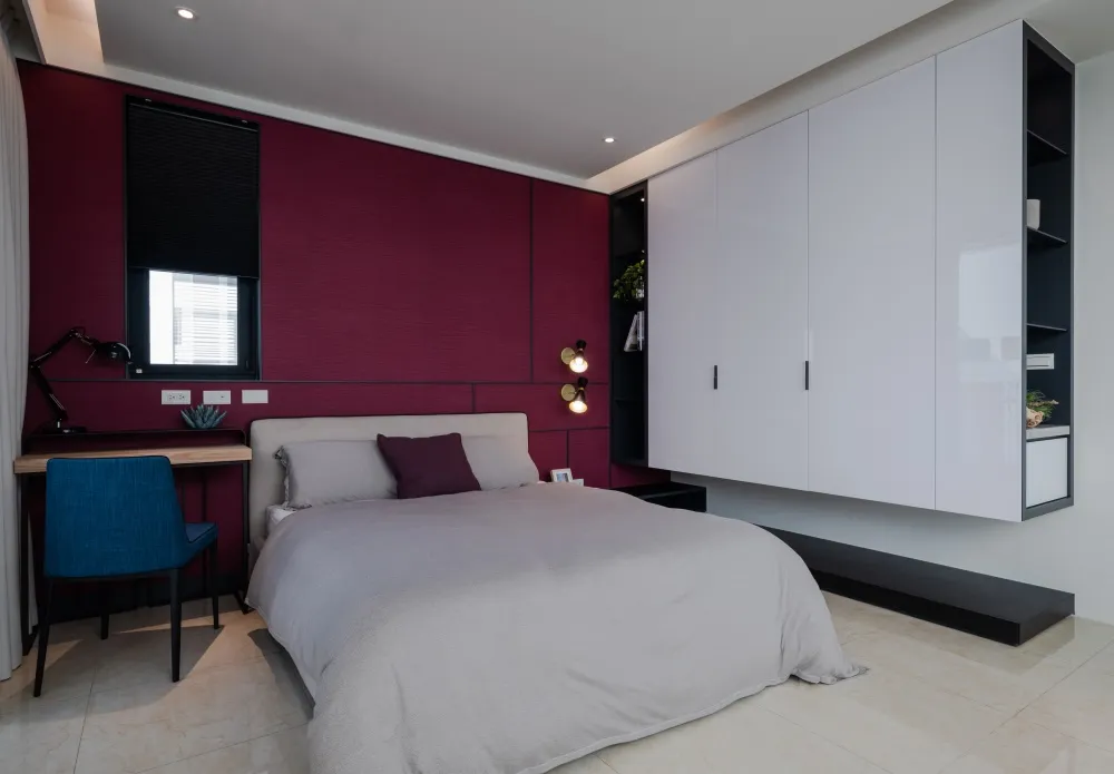 Contemporary bedroom with a monochromatic color scheme featuring a upholstered bed, floating nightstands, and sleek, modern f