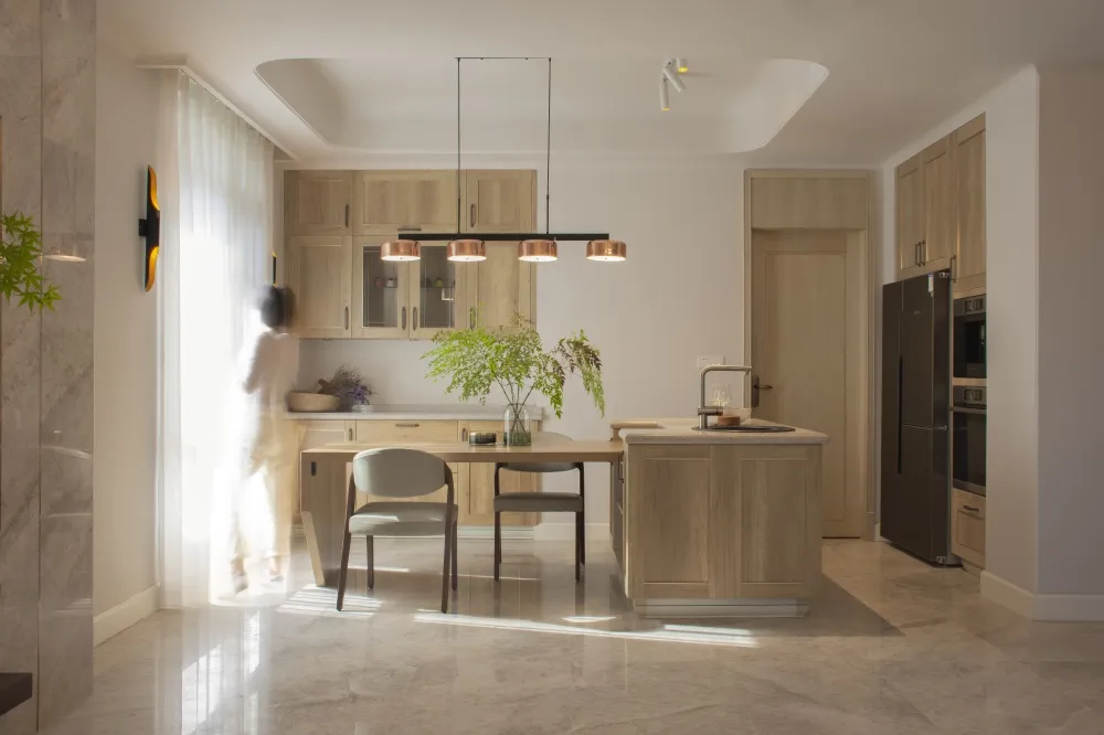 Modern minimalist kitchen interior with wood cabinets and marble floor.