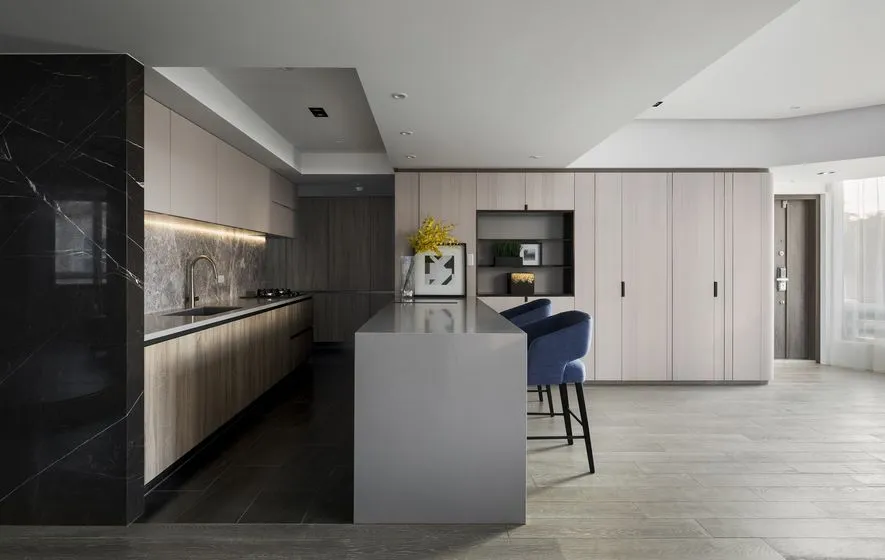 A modern minimalist kitchen with a marble countertop, wooden cabinets, and a central island.