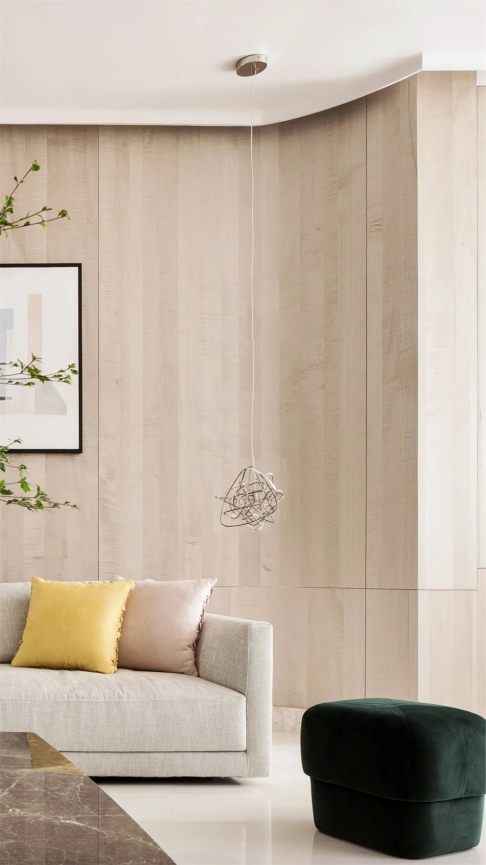A modern minimalist living room featuring white walls, wood paneling, and a comfortable seating area.