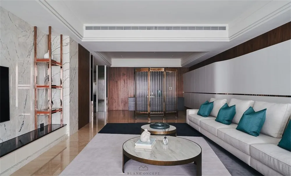 Modern minimalist living room with marble countertops and oak walls, featuring a comfortable seating arrangement and decorati