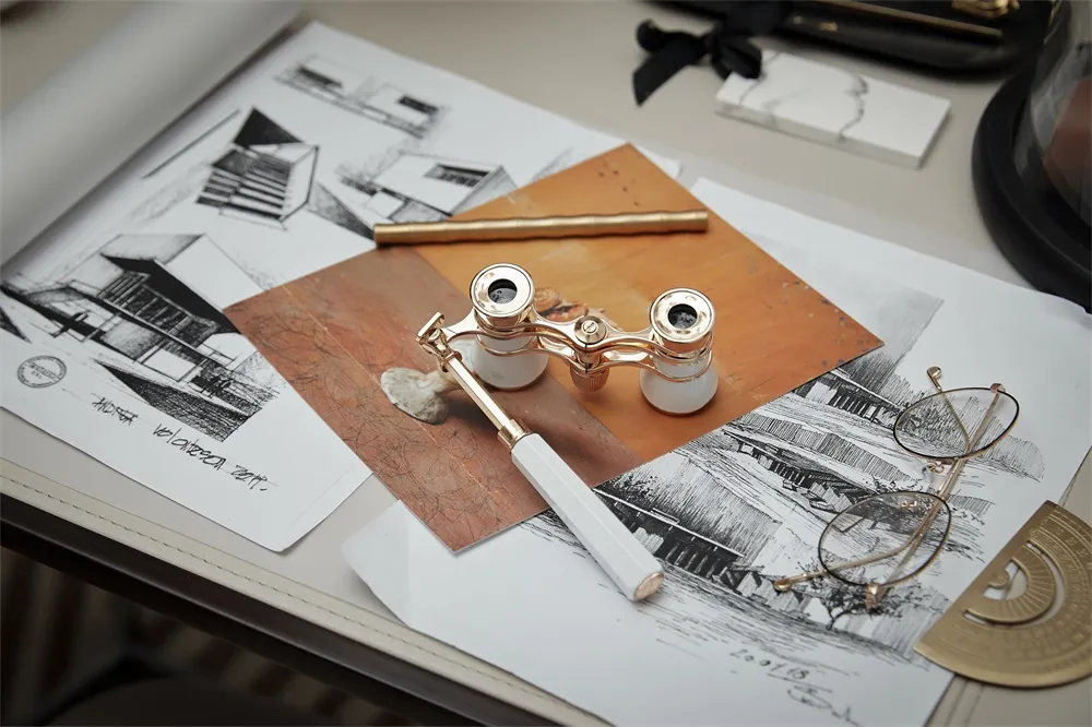 A collection of architectural sketches and design tools on a workspace desk.