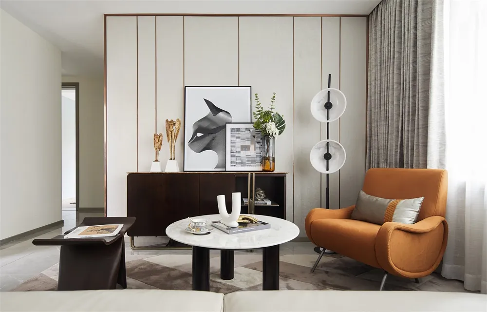 Modern living room with concrete walls, orange armchair, and abstract art.