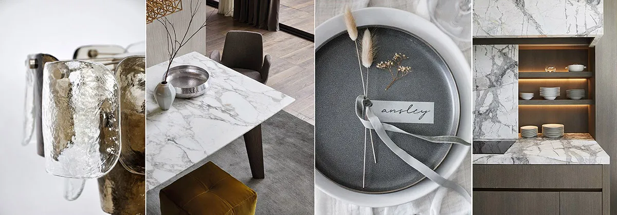 Modern dining room with marble table, chairs, and flooring, featuring decorative elements such as dried grasses and a placeca