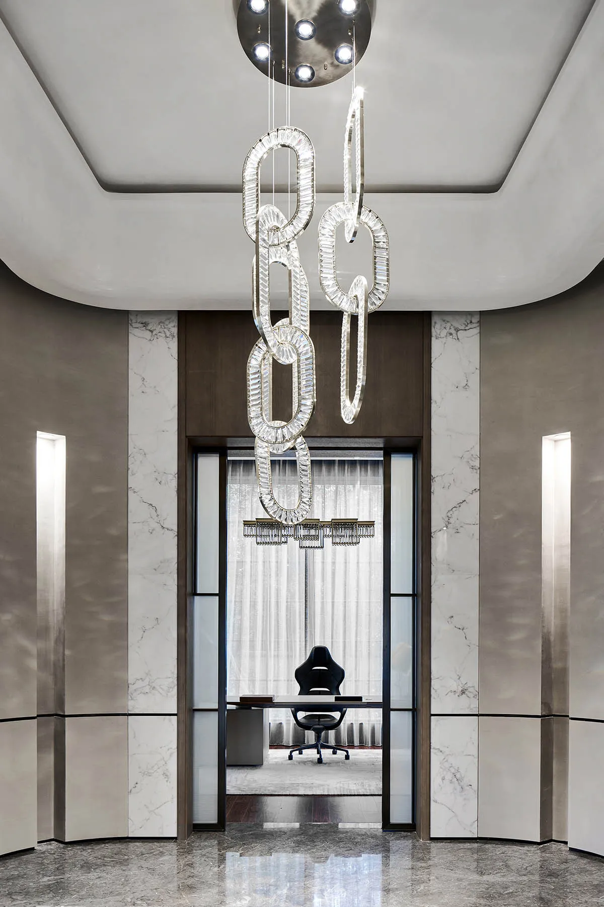 A modern executive office featuring marble finishes and elegant lighting fixtures.