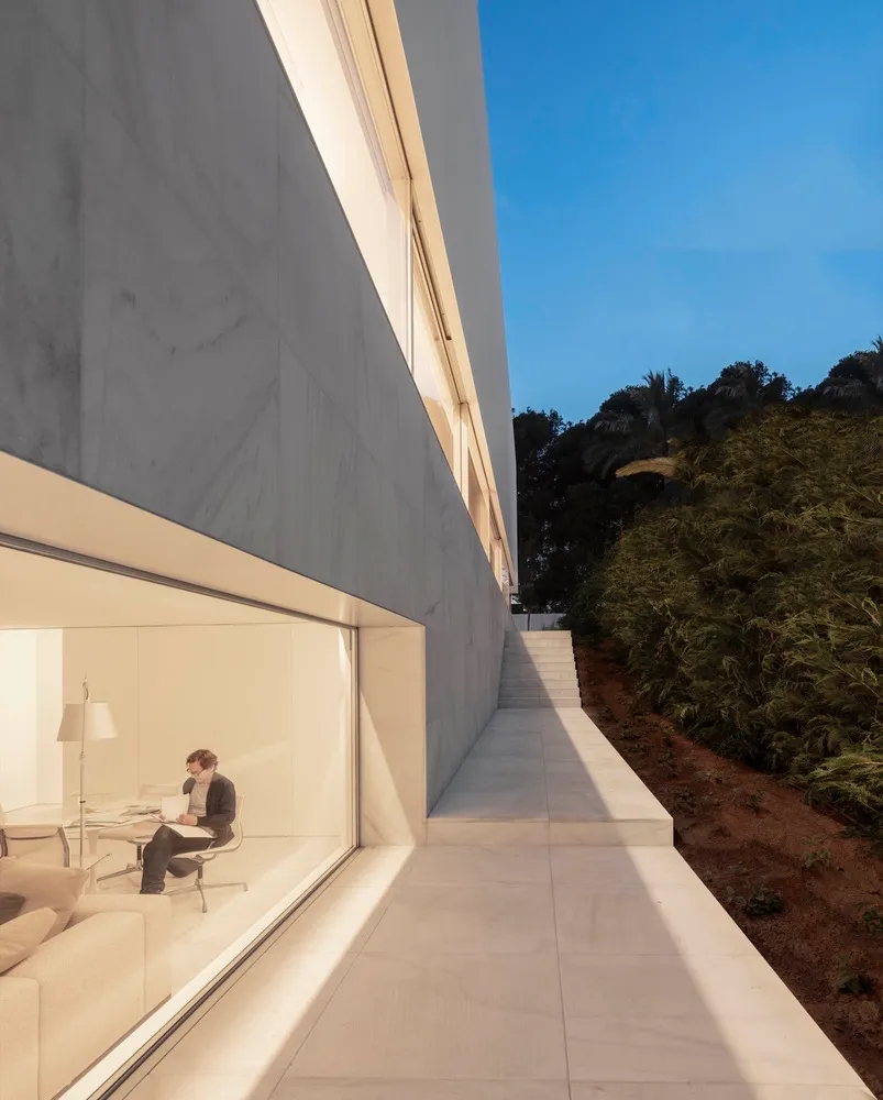 Modern residential building with concrete exterior and large windows