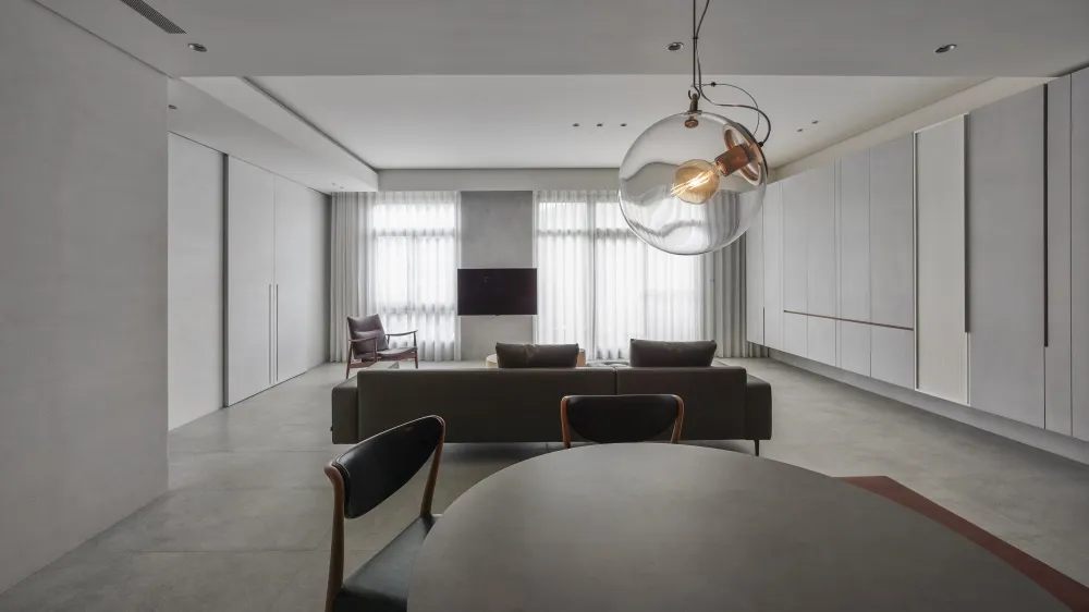 Modern living room with concrete floors and a minimalist design.