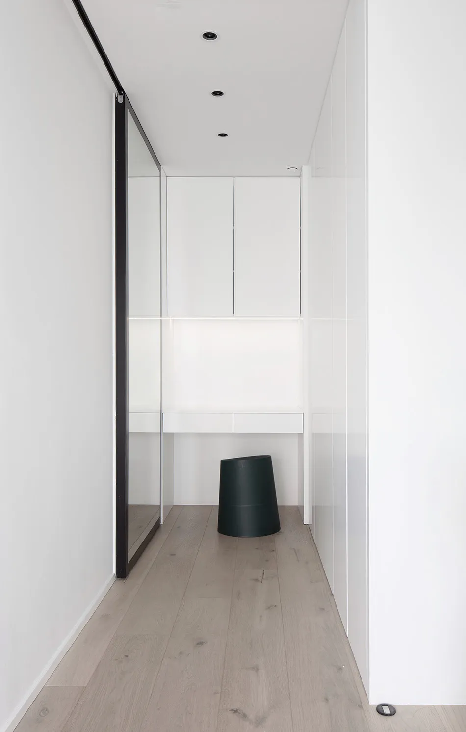 A well-lit, minimalist interior space featuring modern flat-pack cabinets.
