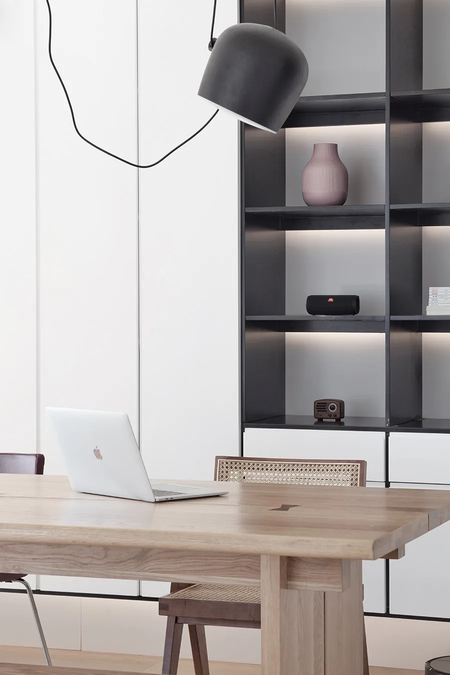 A modern home office with a wooden desk, minimalist design, and metal accents.