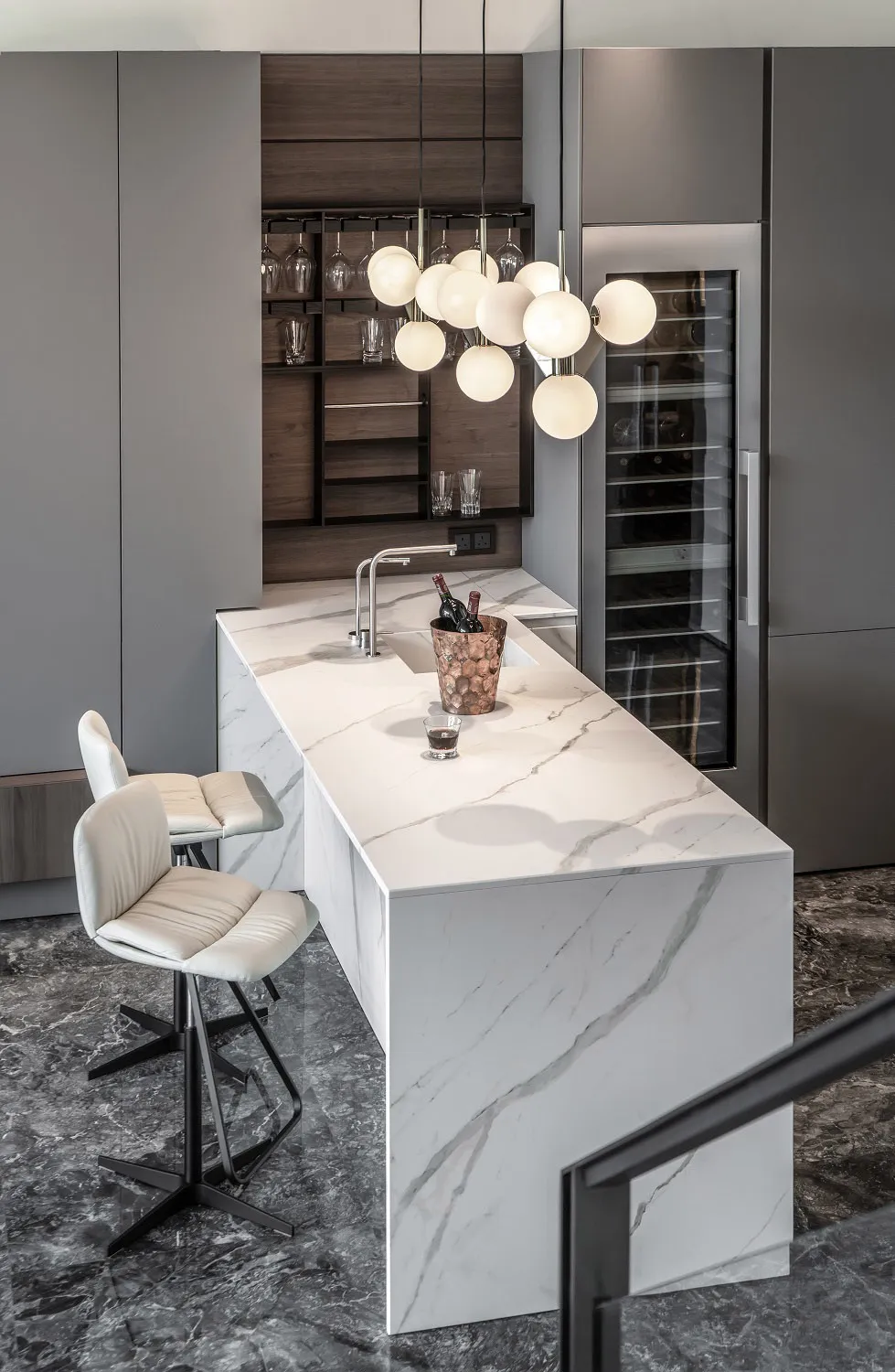 A modern kitchen with marble countertops features a sleek, minimalist design with a focus on functionality and elegance.