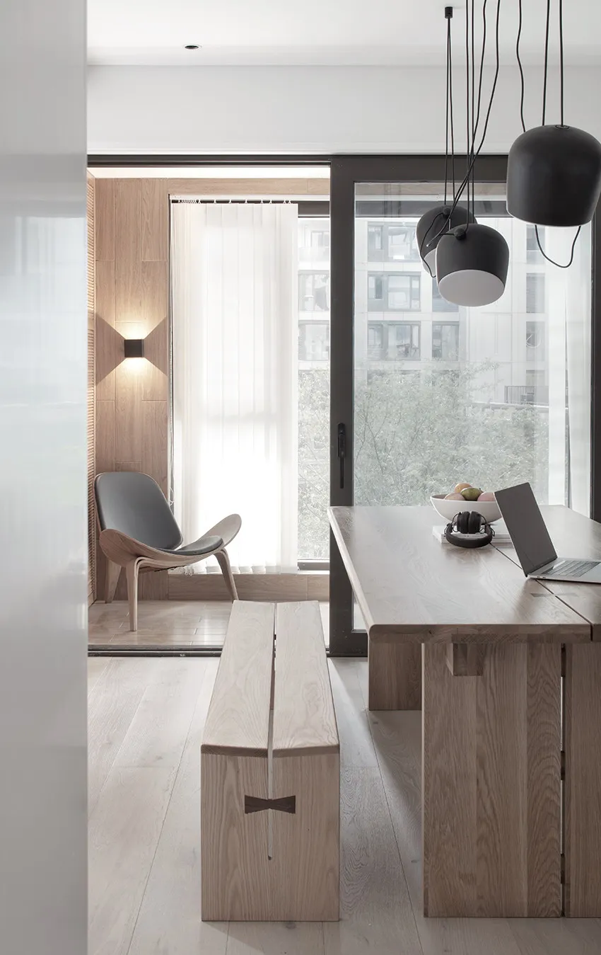 Contemporary living room with minimalist design and wooden furniture and flooring.