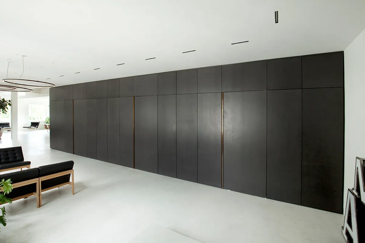 A minimalist office space featuring concrete and metal materials.