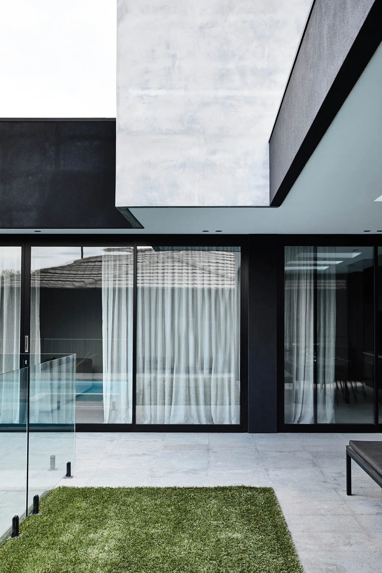 A sleek, modern exterior featuring glass and concrete materials.