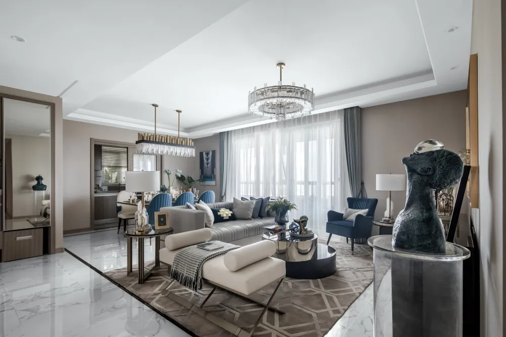 A modern living room with marble floors, glass chandeliers, and fabric furniture.