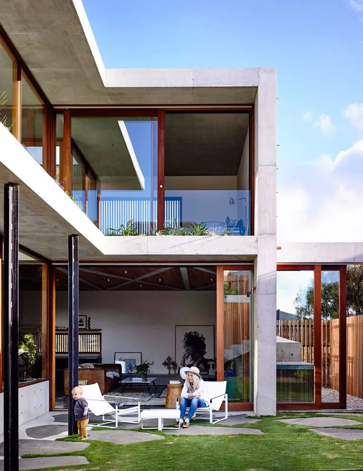 A modern residential home featuring concrete and glass materials.