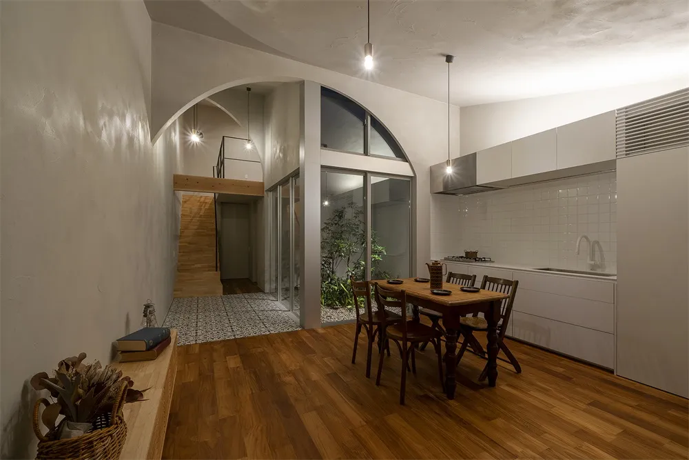 A minimalist residential kitchen featuring white and wooden elements.