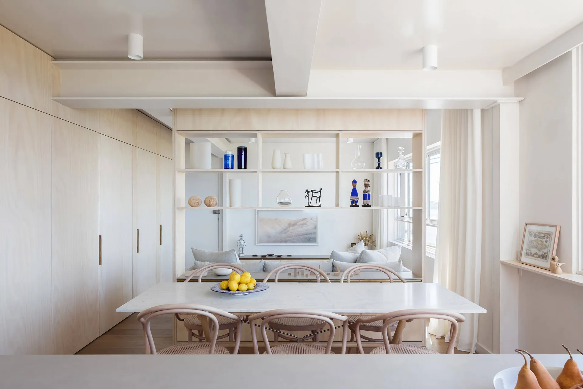 A minimalist residential space featuring white wood finishes and clean lines.