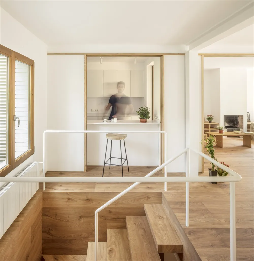 Minimalist residential kitchen featuring wood flooring and minimalist cabinetry.