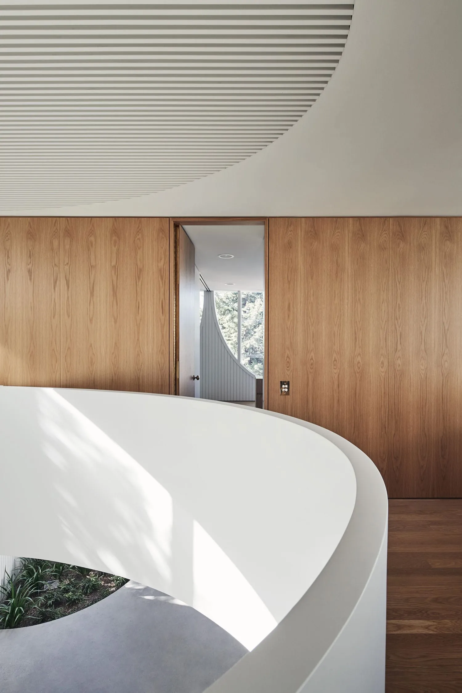 A modern interior design featuring minimalist concrete and wood elements.