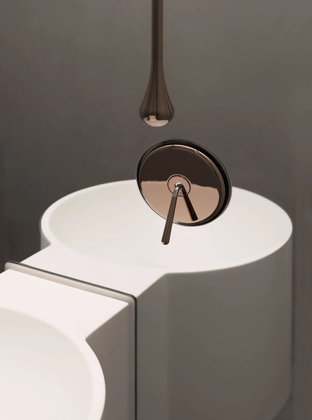 Close-up of a modern white bathroom sink with a ceramic faucet.