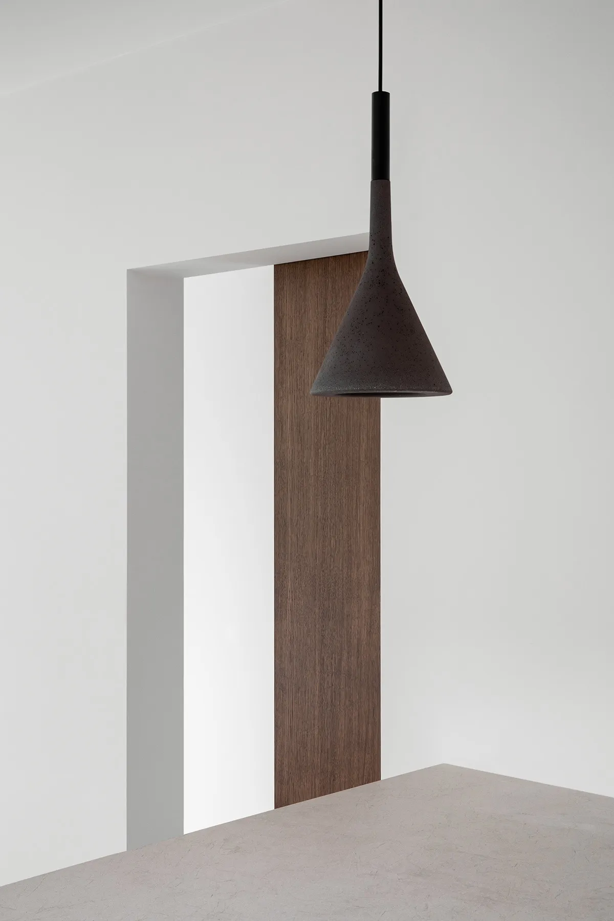 A minimalist interior design featuring a wooden panel.