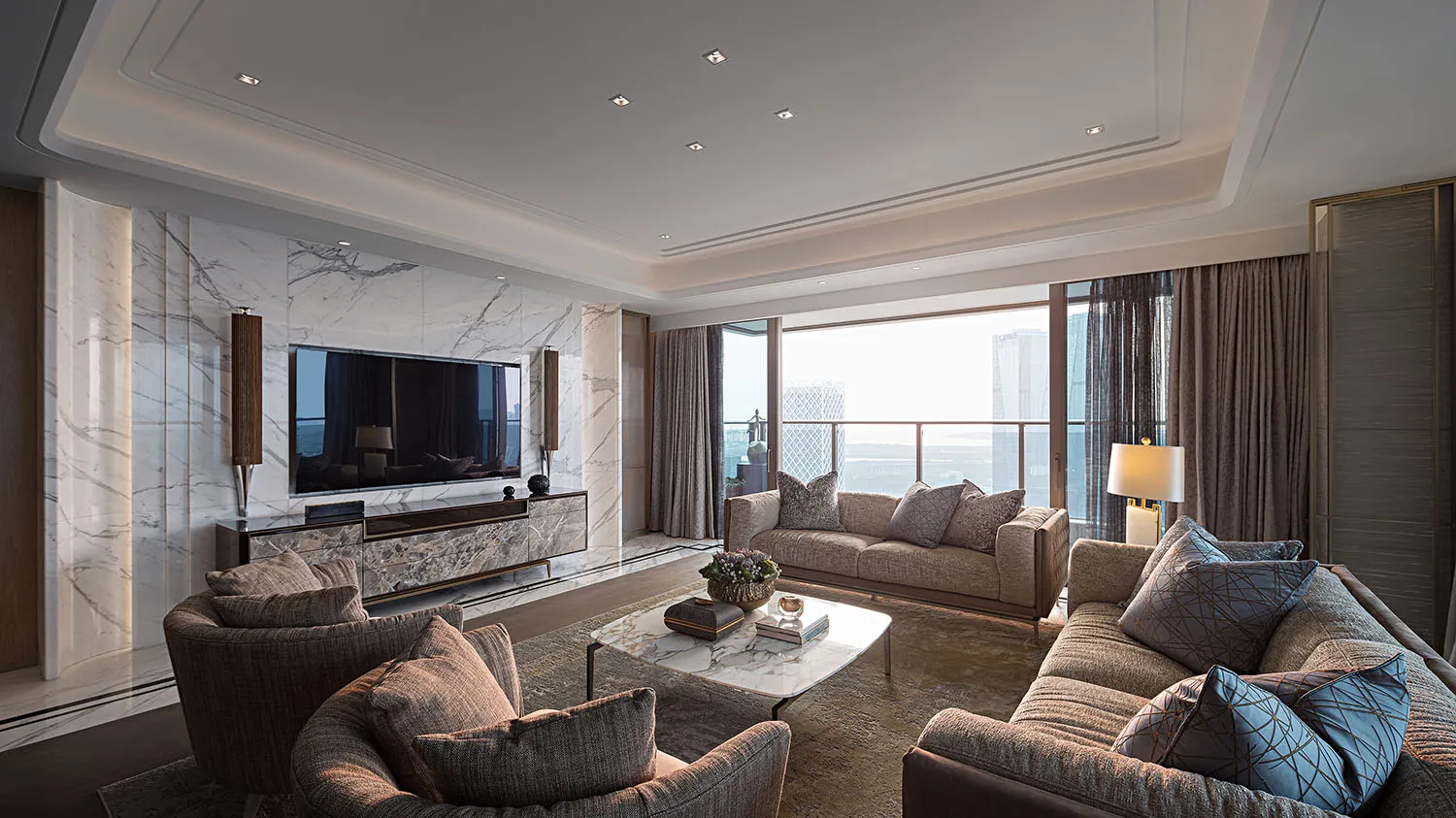 A modern living room featuring marble walls and furniture, with large windows overlooking a cityscape.