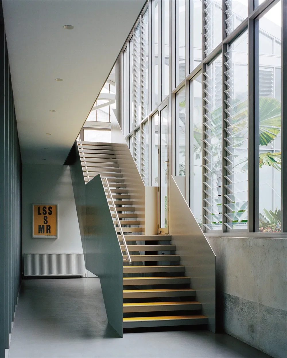 A modern industrial staircase featuring metal and wood materials.