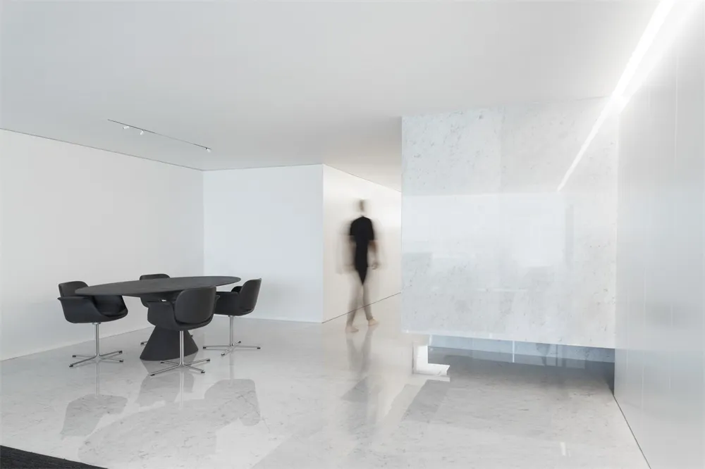 A minimalist office space featuring a marble floor plan.