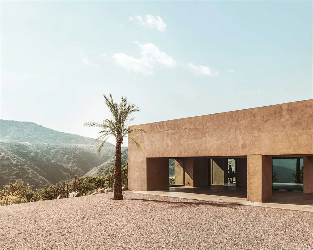 Modern residential building with concrete exterior and glass window.