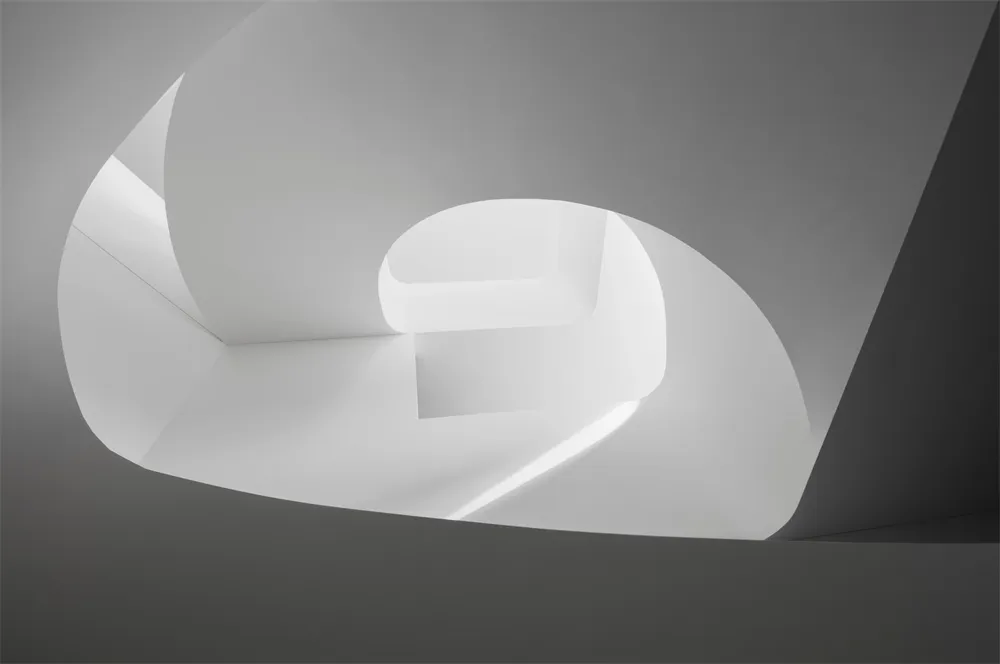 A modern white interior with concrete elements.
