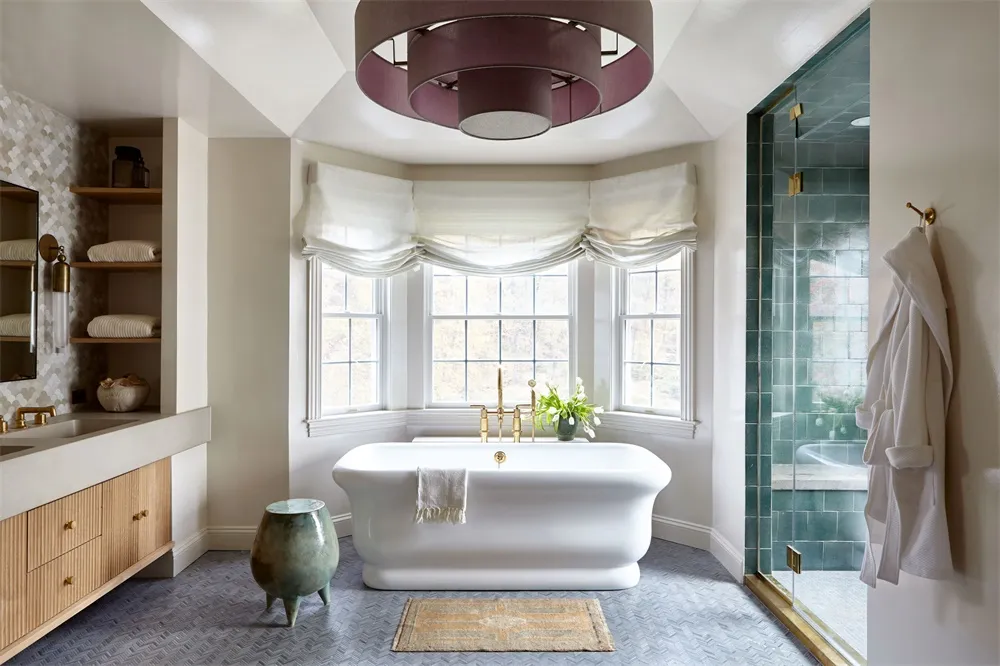 Modern bathroom with a freestanding bathtub, marble flooring, glass shower enclosure, and minimalist design.