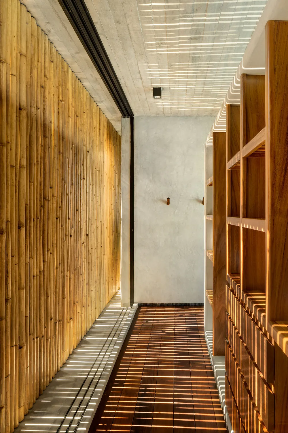 A modern corridor interior with bamboo-laminated board walls and hardwood floors.