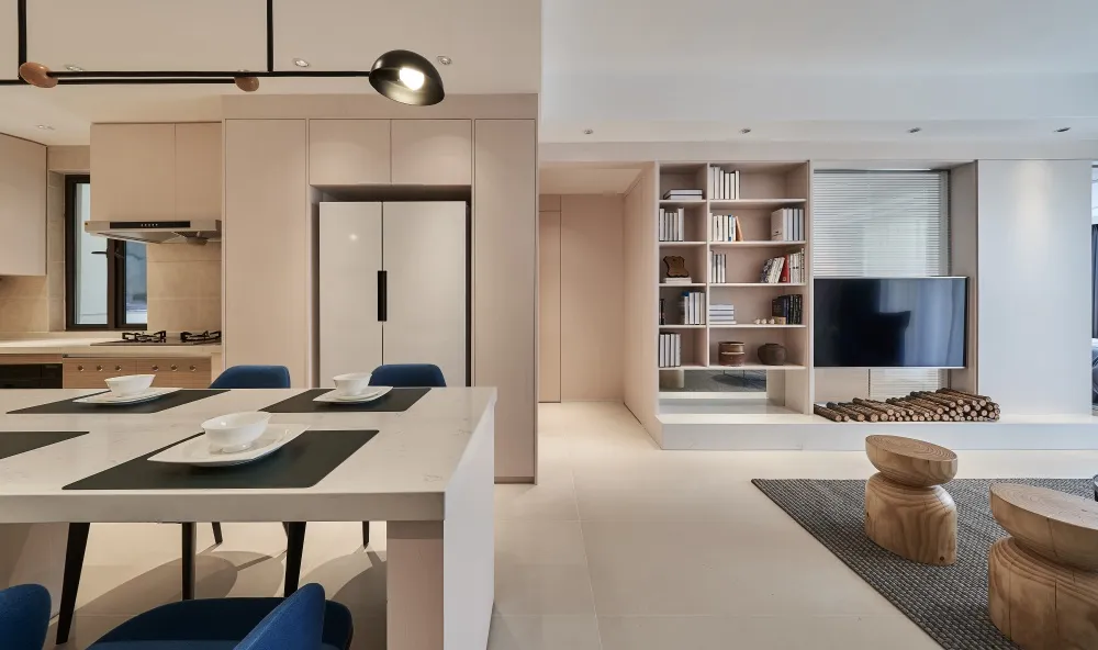 Modern minimalist living room with white walls, wooden floors, and a combination of soft and hard materials.