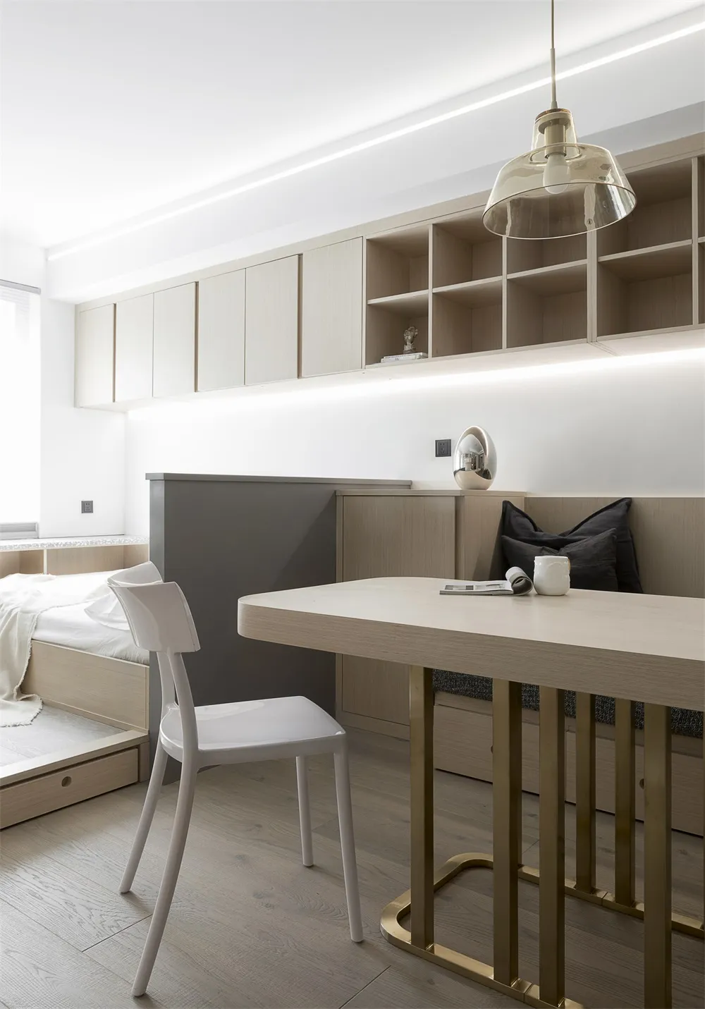 A modern minimalist bedroom featuring sleek, contemporary furniture and a clean, uncluttered design.
