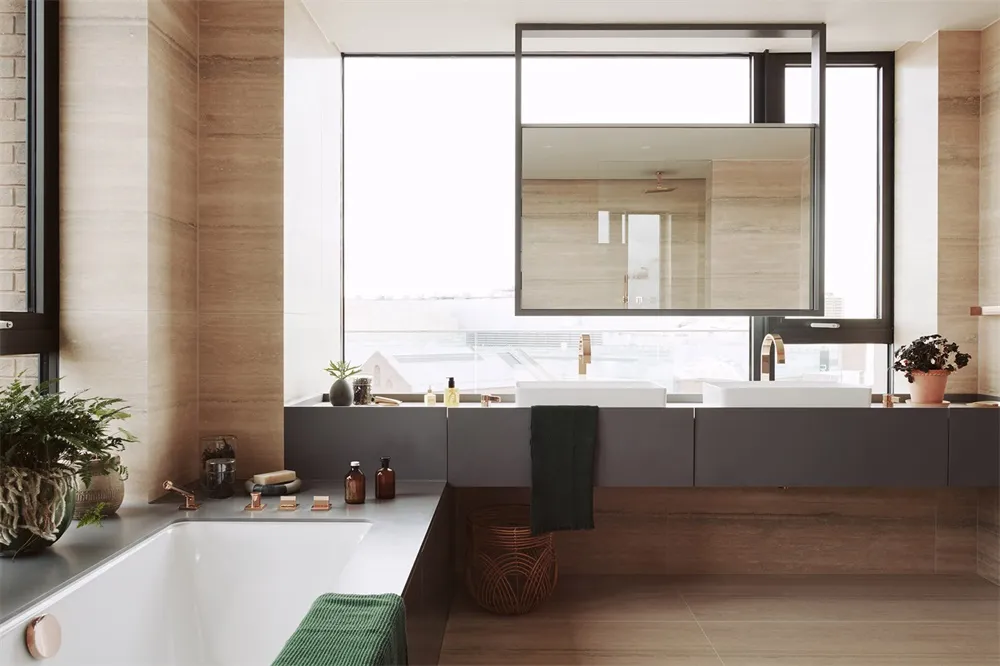 A minimalist bathroom featuring modern design elements, sandstone tiles, and wooden accents.
