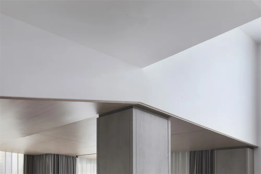 A minimalist interior space featuring wooden elements and light tones.