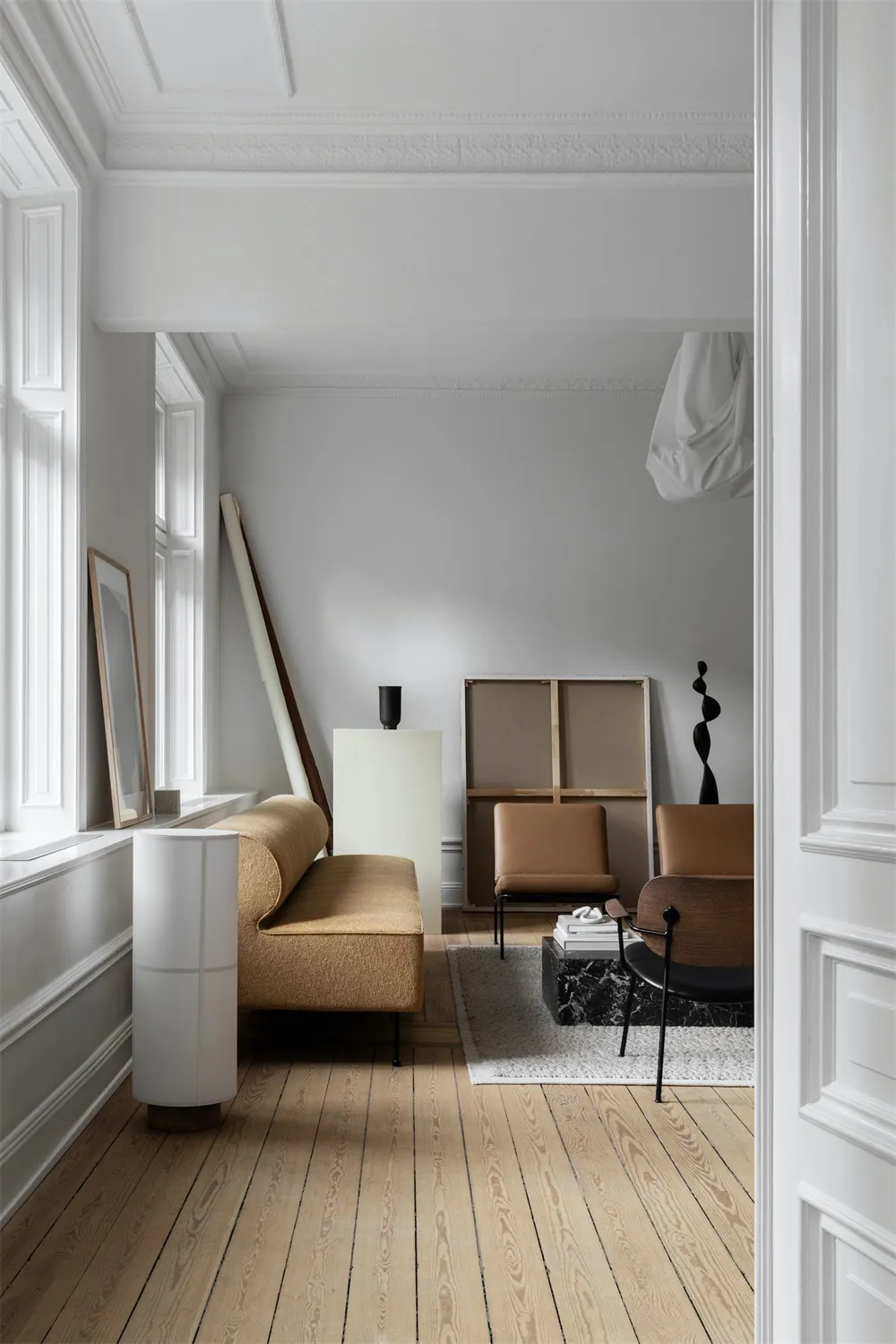 Modern living room with minimalist furniture in white color palette.
