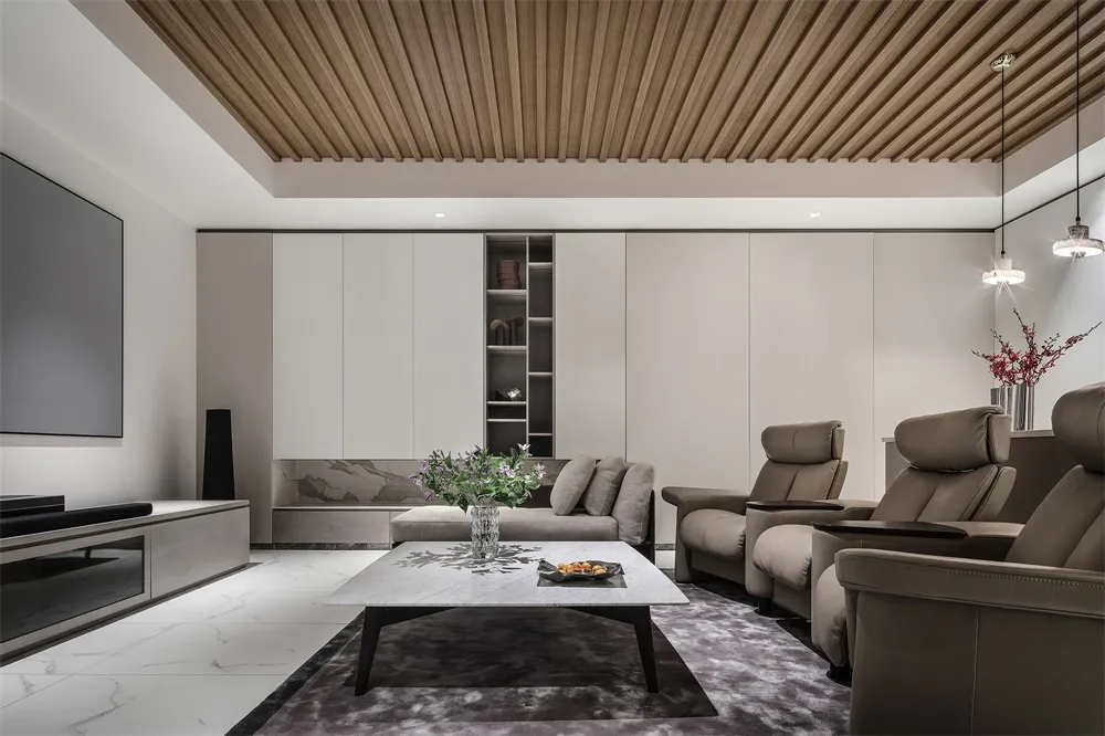 Modern minimalist living room featuring marble coffee table and leather recliners.