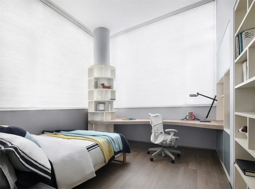 A modern bedroom with a wooden bed frame, a white desk, and built-in shelves.