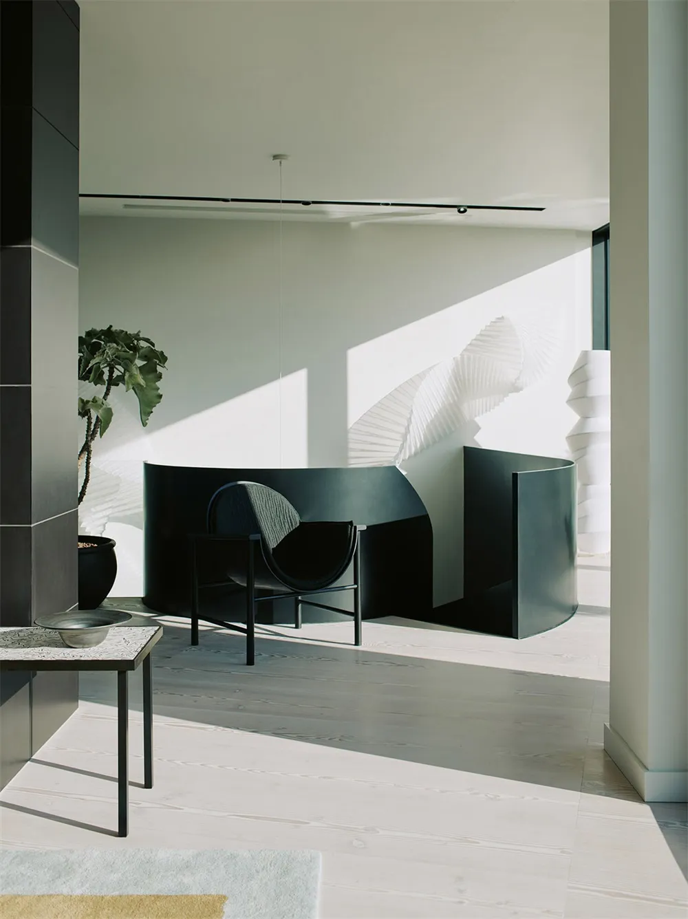 Modern interior design featuring black metal chair and glass partition