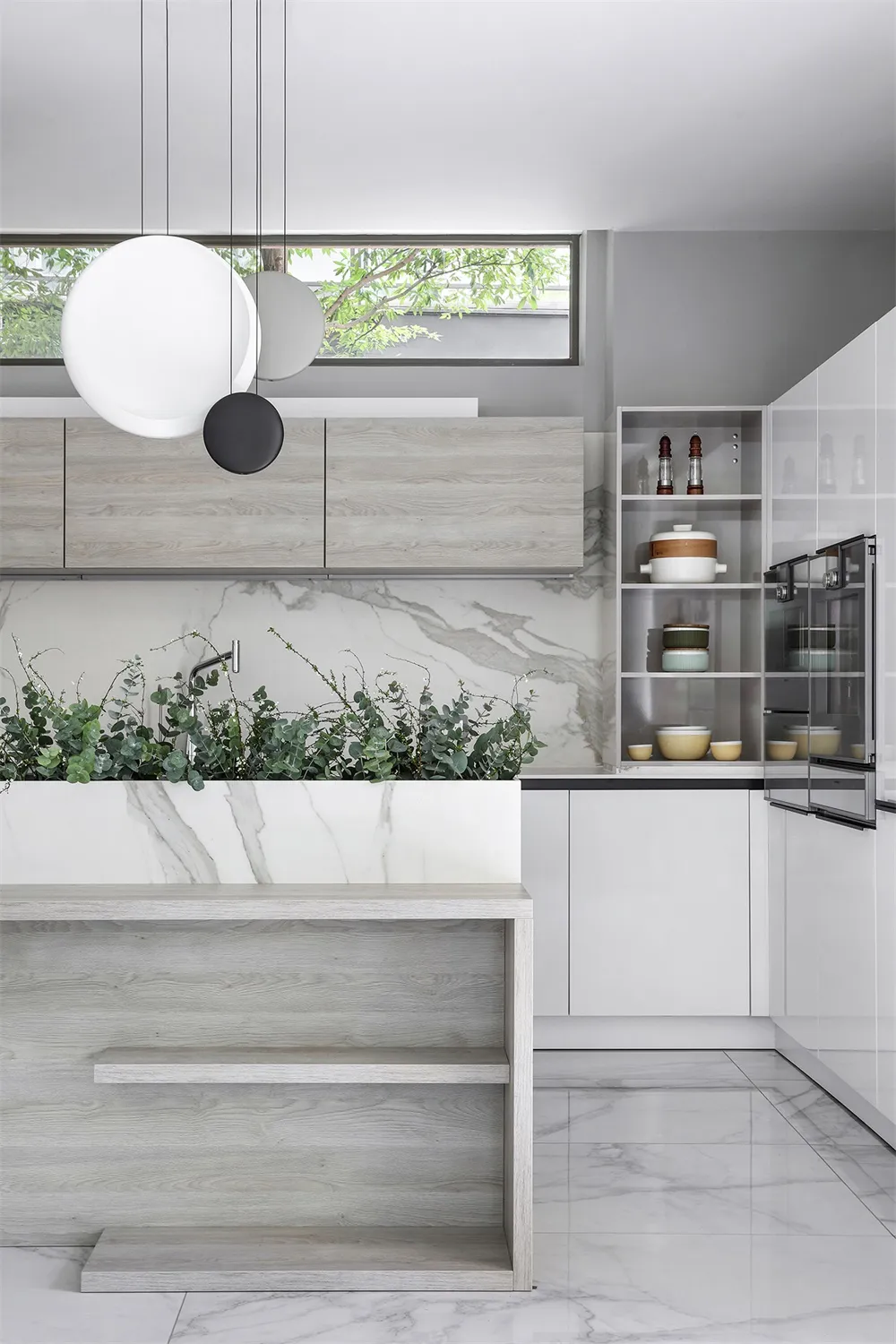 Modern kitchen featuring marble countertops and flooring.