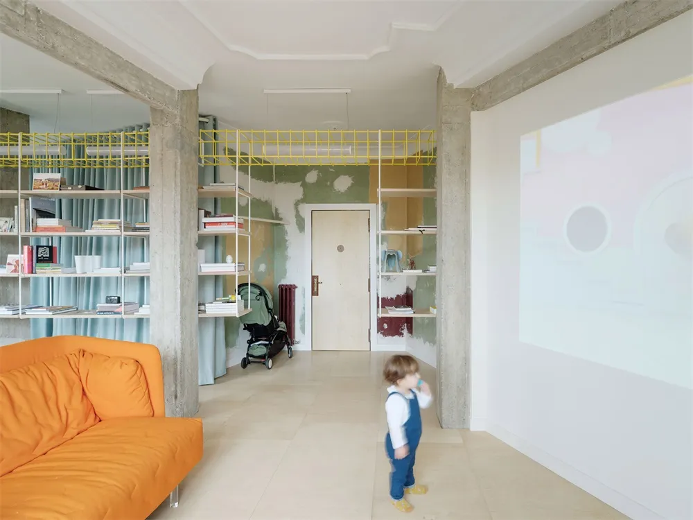 Minimalist children's room featuring concrete, wood, and fabric materials