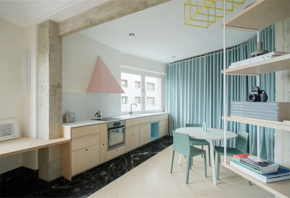 A modern, minimalist kitchen with concrete countertops, marble flooring, and wooden cabinets and shelves.