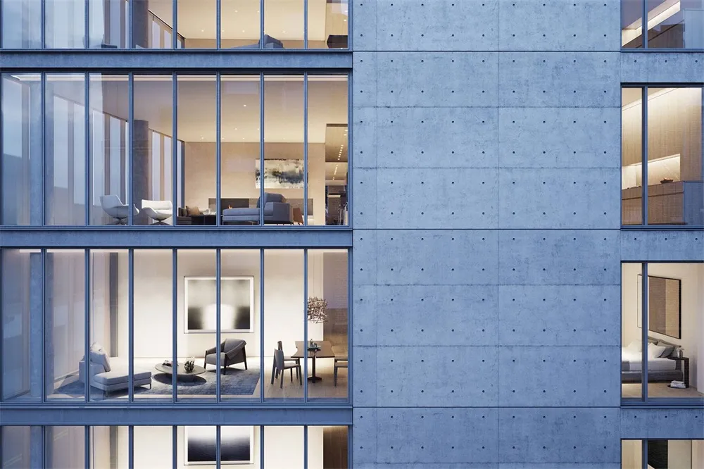 Modern office space with concrete walls and large windows.