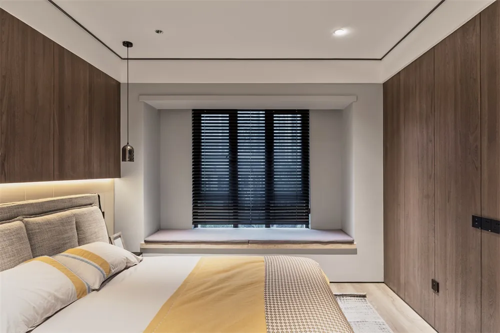 Modern bedroom featuring a bed with brown wooden frame and minimalist design.